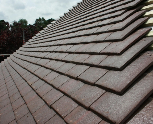Side view of a roof with brown shingles