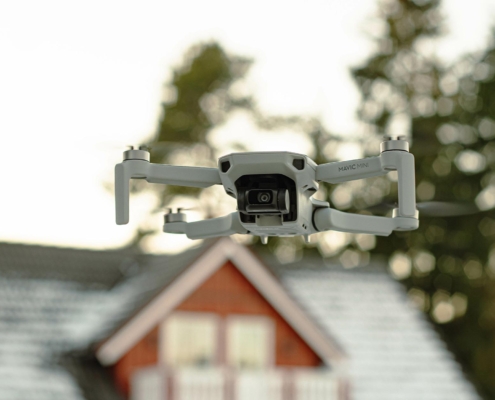 Front view of a drone flying in front of a roof